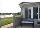 Inviting patio with a scenic view of the lake, featuring a cozy bench and ample seating space at 7357 Lake Lakota Dr, Indianapolis, IN 46217