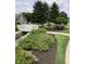 Scenic community pond with a white picket bridge surrounded by lush landscaping at 7357 Lake Lakota Dr, Indianapolis, IN 46217