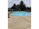 Sparkling blue community pool with sun loungers and ample seating for residents to enjoy on a summer day at 7357 Lake Lakota Dr, Indianapolis, IN 46217