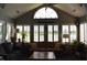 Bright sunroom with vaulted ceiling, wall of windows with shutters and comfortable seating at 7357 Lake Lakota Dr, Indianapolis, IN 46217