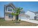 Two-story home featuring a brick and siding exterior, with an attached three car garage at 7510 Hillway Dr, Camby, IN 46113