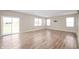 Inviting living room with sliding glass doors to patio, light walls, and hardwood floors at 7510 Hillway Dr, Camby, IN 46113