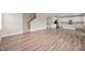 Open-concept living space featuring wood flooring and staircase leading to the upper level at 7510 Hillway Dr, Camby, IN 46113