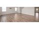 Bright living room boasts gorgeous wood floors, neutral walls, and plentiful natural light at 7510 Hillway Dr, Camby, IN 46113