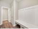 Mud room with a wooden bench, coat hooks, and wood-look flooring at 7510 Hillway Dr, Camby, IN 46113