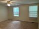 Bedroom featuring two windows with blinds, neutral walls, and a ceiling fan at 7667 Madden Ln, Fishers, IN 46038