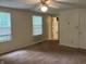Bedroom featuring two windows, neutral walls, carpet floors, and a ceiling fan at 7667 Madden Ln, Fishers, IN 46038