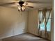 Bedroom with a ceiling fan, window with curtains at 7667 Madden Ln, Fishers, IN 46038