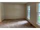 A spacious bedroom with carpet flooring and natural light from two windows at 7667 Madden Ln, Fishers, IN 46038