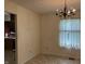 Dining room with linoleum floor, light walls, chandelier and sheer curtains at 7667 Madden Ln, Fishers, IN 46038