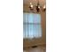 Dining room with chandelier and sheer curtain covered window at 7667 Madden Ln, Fishers, IN 46038