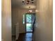 Foyer featuring hardwood floors, chandelier lighting, staircase, and a view of the front entrance at 7667 Madden Ln, Fishers, IN 46038