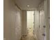 Hallway with doors and closets leads to a bathroom at 7667 Madden Ln, Fishers, IN 46038