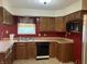 Kitchen with wooden cabinets, red walls and linoleum floor at 7667 Madden Ln, Fishers, IN 46038