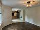 Open-concept living space with modern flooring leading to a kitchen with wooden cabinets at 7667 Madden Ln, Fishers, IN 46038