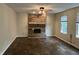 Spacious living room with wood flooring, brick fireplace, and natural light at 7667 Madden Ln, Fishers, IN 46038