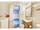 Bright bathroom featuring a walk-in tub, vanity with wood accents, and neutral walls at 7724 Eagle Valley Pass, Indianapolis, IN 46214