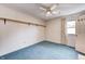 Bedroom with blue carpet, open shelving and a ceiling fan at 7724 Eagle Valley Pass, Indianapolis, IN 46214