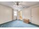 Bedroom with a ceiling fan, blue carpet, and closet at 7724 Eagle Valley Pass, Indianapolis, IN 46214