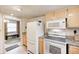 Bright kitchen featuring white appliances, granite countertops and tile flooring at 7724 Eagle Valley Pass, Indianapolis, IN 46214