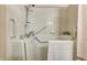 A detailed view of the walk-in tub, equipped with safety features and a showerhead at 7724 Eagle Valley Pass, Indianapolis, IN 46214