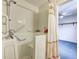 Close-up of a walk-in tub in bathroom, with safety bars and a showerhead at 7724 Eagle Valley Pass, Indianapolis, IN 46214