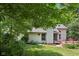 Back exterior view featuring spacious wooden deck and lush landscaping at 7831 Bayridge Dr, Indianapolis, IN 46236
