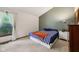 Bedroom featuring a large window, neutral carpet and a queen size bed at 7831 Bayridge Dr, Indianapolis, IN 46236