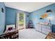 Bright bedroom with blue painted walls, carpet floors, and a double hung window at 7831 Bayridge Dr, Indianapolis, IN 46236