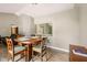 Open dining area with a view of the living room and kitchen bar at 7831 Bayridge Dr, Indianapolis, IN 46236