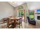 Inviting dining area with a large window and glass doors leading to the deck at 7831 Bayridge Dr, Indianapolis, IN 46236