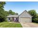 Charming one-story home featuring a well-maintained lawn and attached two-car garage at 7831 Bayridge Dr, Indianapolis, IN 46236