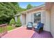 Charming front porch with blue wicker seating area and lovely landscape at 7831 Bayridge Dr, Indianapolis, IN 46236