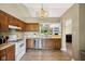 Updated kitchen features laminate floors, stainless appliances, wood cabinets, and a view to the living room at 7831 Bayridge Dr, Indianapolis, IN 46236