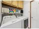 Well-lit laundry room featuring front-loading washer and dryer and storage at 7831 Bayridge Dr, Indianapolis, IN 46236