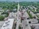 An aerial view captures a city with new construction and established residential areas, highlighting urban development at 80 Monon Blvd, Carmel, IN 46032