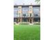 Modern townhome showcasing a well-maintained lawn, front patio, and contemporary design at 80 Monon Blvd, Carmel, IN 46032