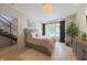 This main bedroom features a light color scheme, plenty of natural light, and a spacious layout with stairs nearby at 80 Monon Blvd, Carmel, IN 46032