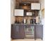 Stylish wet bar with dark wood cabinets, marble countertop, and beverage cooler for entertaining at 80 Monon Blvd, Carmel, IN 46032