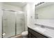 Updated bathroom featuring a shower with glass door and granite countertop at 802 Lawrence Ave, Indianapolis, IN 46227