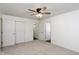 Clean bedroom featuring fresh neutral carpet, white paint, ceiling fan and a closet at 802 Lawrence Ave, Indianapolis, IN 46227