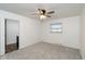 Bright bedroom with neutral carpet, ceiling fan, and window at 802 Lawrence Ave, Indianapolis, IN 46227