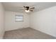 Cozy bedroom with neutral carpet, fresh white paint, and a ceiling fan at 802 Lawrence Ave, Indianapolis, IN 46227