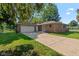 Charming brick home with attached garage and well-maintained lawn at 802 Lawrence Ave, Indianapolis, IN 46227