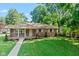 Charming brick ranch home with a well-manicured lawn and inviting walkway at 802 Lawrence Ave, Indianapolis, IN 46227