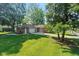Lovely brick home with a spacious front yard and mature trees at 802 Lawrence Ave, Indianapolis, IN 46227
