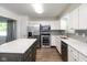 Bright, updated kitchen featuring stainless steel appliances, island, and stylish backsplash at 802 Lawrence Ave, Indianapolis, IN 46227