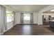 Open living room featuring new floors and ample natural light, next to a modern kitchen at 802 Lawrence Ave, Indianapolis, IN 46227