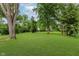 Lush expansive backyard featuring well-maintained lawn and mature trees at 8115 Englewood Rd, Indianapolis, IN 46240