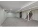 Finished basement featuring carpeted floors and a stairway at 8115 Englewood Rd, Indianapolis, IN 46240